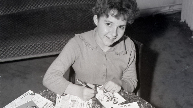 young Brenda Lee signing autographs