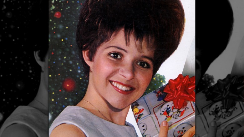 young Brenda Lee holding a Christmas present