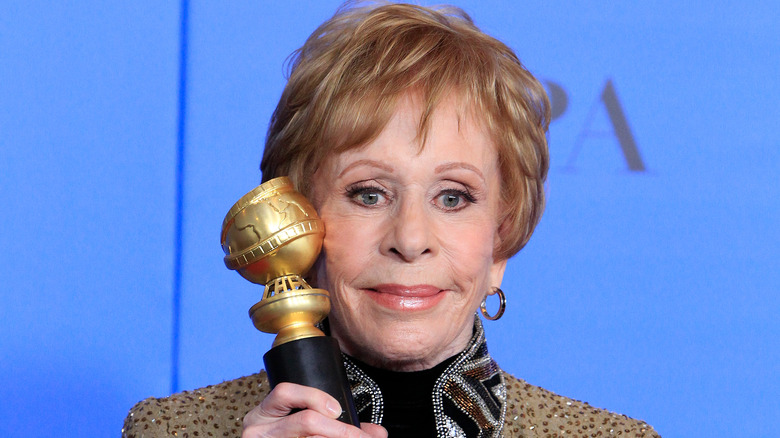 Carol Burnett holding Golden Globe award