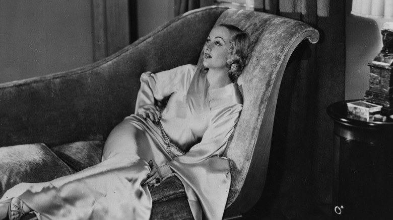 Carole Lombard laying in chaise longue