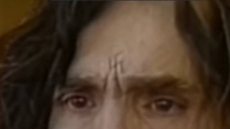 Charles Manson with X on forehead