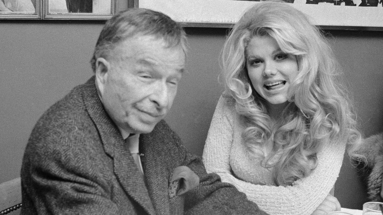 Xavier Cugat and Charo sitting at a table