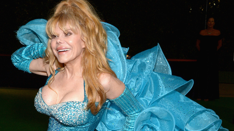 Charo smiling and posing in a blue dress