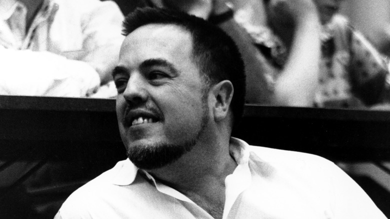 Music folklorist Alan Lomax grins to someone off-camera
