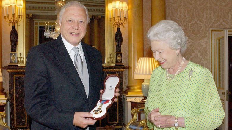 Queen Elizabeth II presents David Attenborough with the Order of Merit