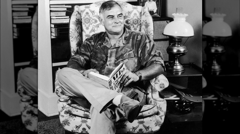 Charles Beckwith sitting reading book