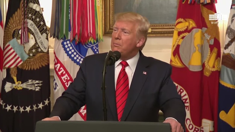 Donald Trump announcing raid at podium