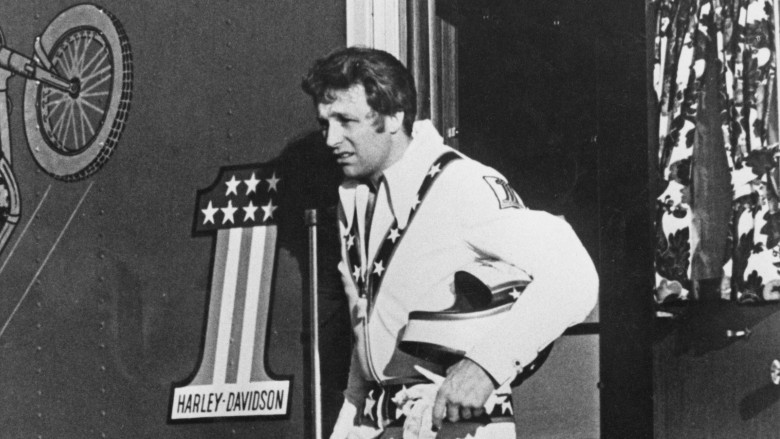 Evel Knievel carrying his helmet