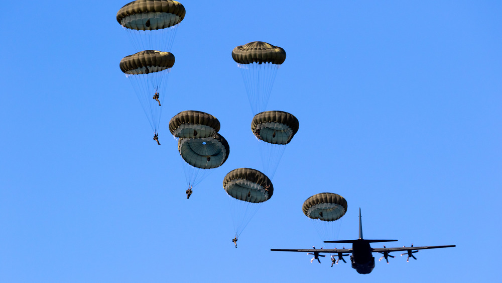 Military paratroopers jumping from a plane.