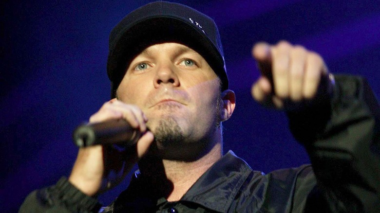 Fred Durst points to someone in the crowd at a concert