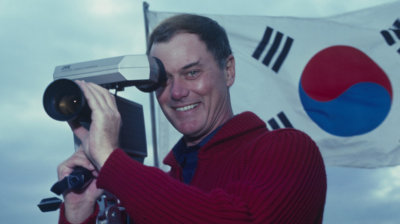 Larry Hagman plays with a camera
