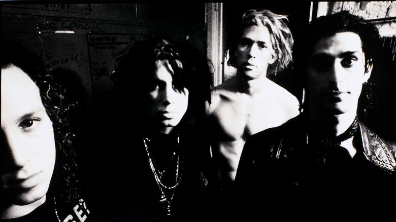 A black and white photo of the band Jane's Addiction in their early days