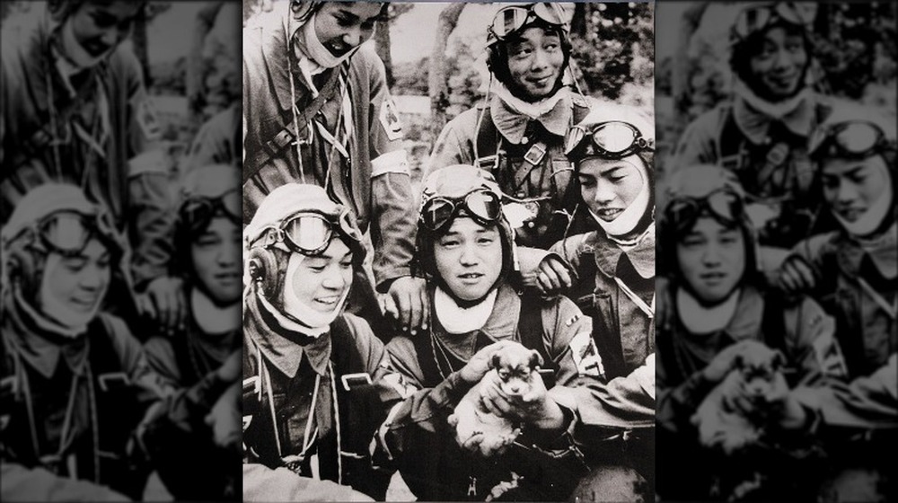 kamikaze pilots smiling and holding puppy