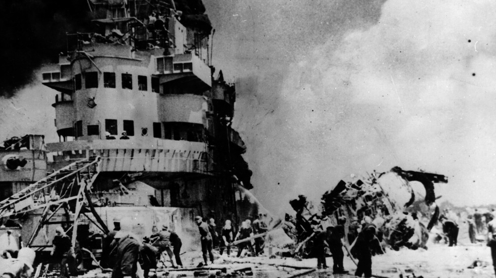 aftermath of kamikaze attack with ship in ruins