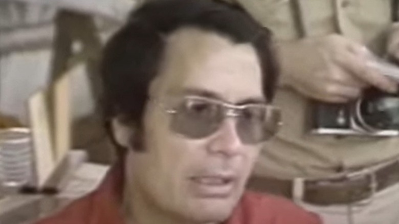 Jim Jones wearing sunglasses
