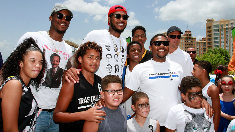 Jimmy Butler posing with a group of kids volunteers