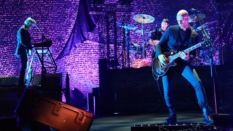 James Iha, Josh Freese, and Billy Howerdel of A Perfect Circle performing onstage