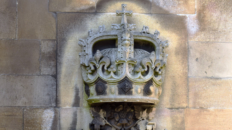 The bas-relief of a crown juts out above a window at St. George's Chapel