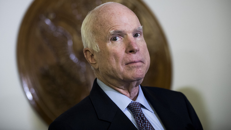 Senator John McCain looks up