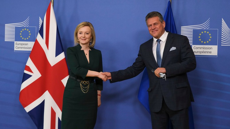 Liz Truss shaking hands with an EU man