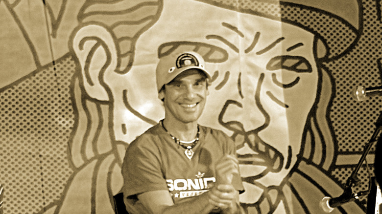 Manu Chao in front of artwork of Che Guevara