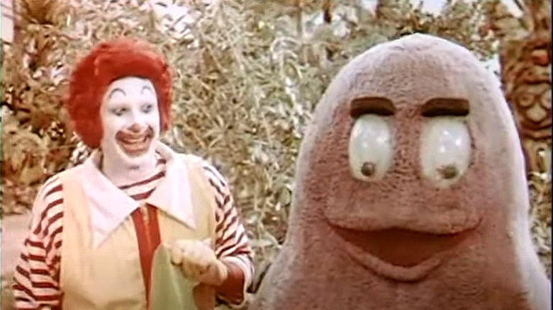 Ronald McDonald grimacing at Grimace