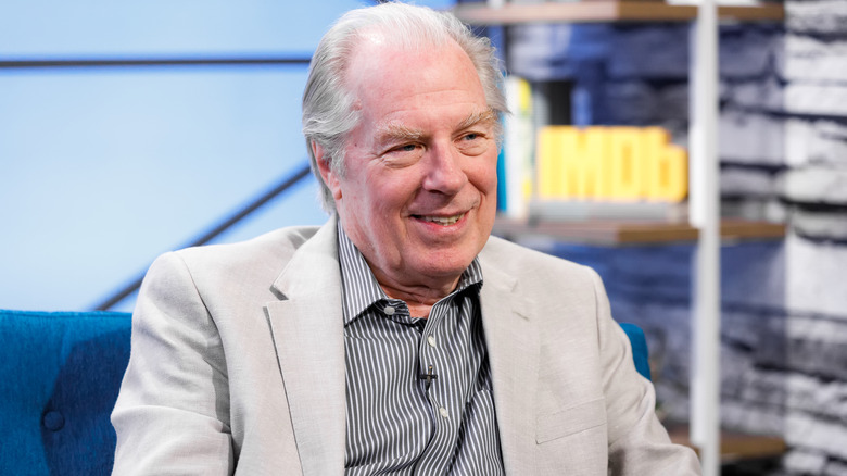 A seated Michael McKean smiling