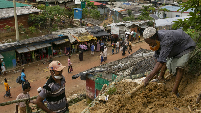Workers clear space for a Rohingya refugee camp