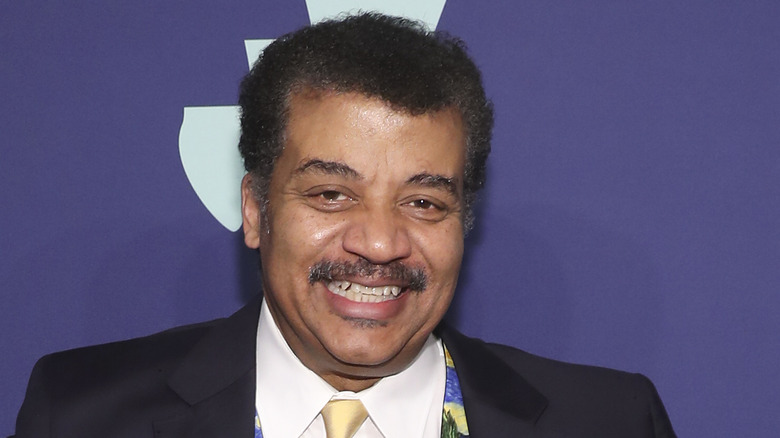 Neil deGrasse Tyson smiling in a candid photo