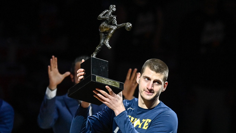 Nikola Jokić holiding his MVP trophy