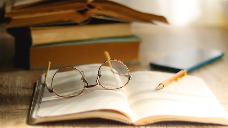 Glasses on an open book in a study room