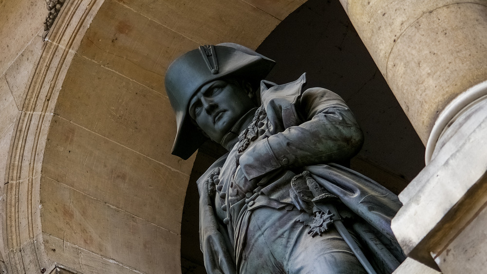 Napoleon statue with arm in vest