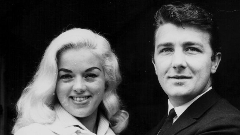 Richard Dawson and his first wife Diana Dors smile and embrace