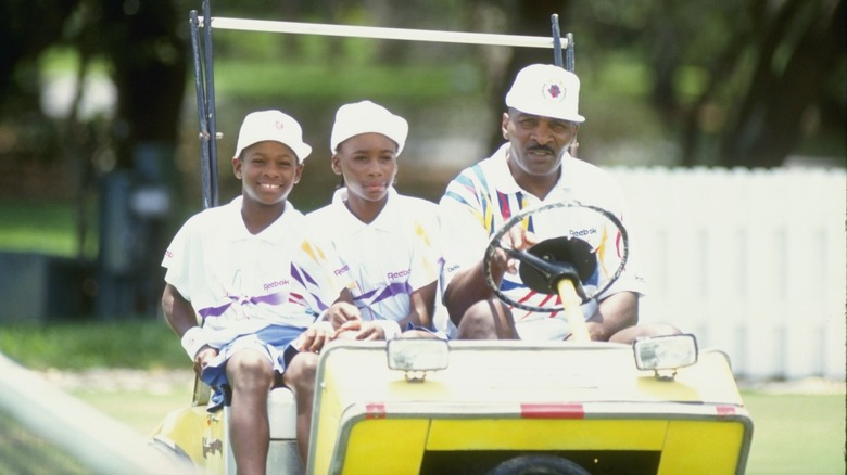 Richard, Serena, and Venus Williams in golf cart