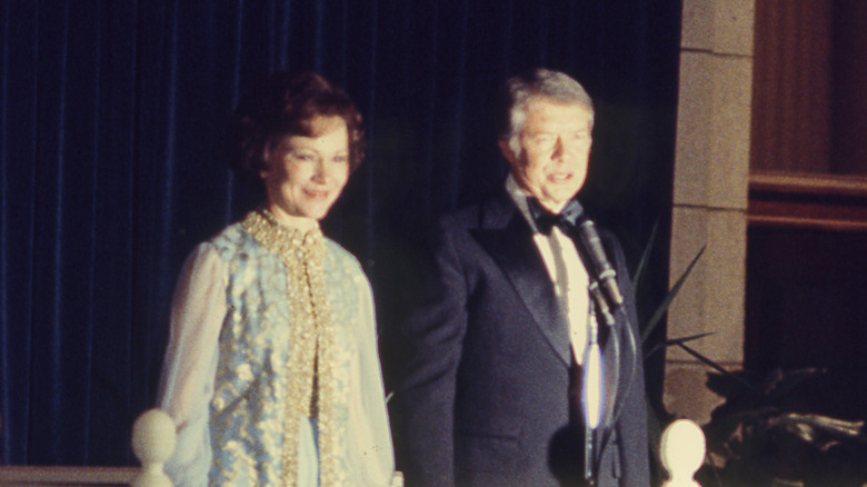 Rosalynn and Jimmy Carter speak in formal attire