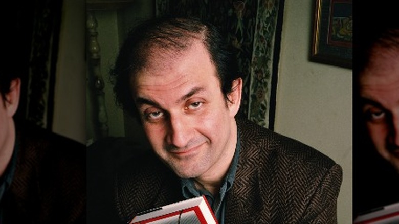 Salman Rushdie with a copy of The Satanic Verses