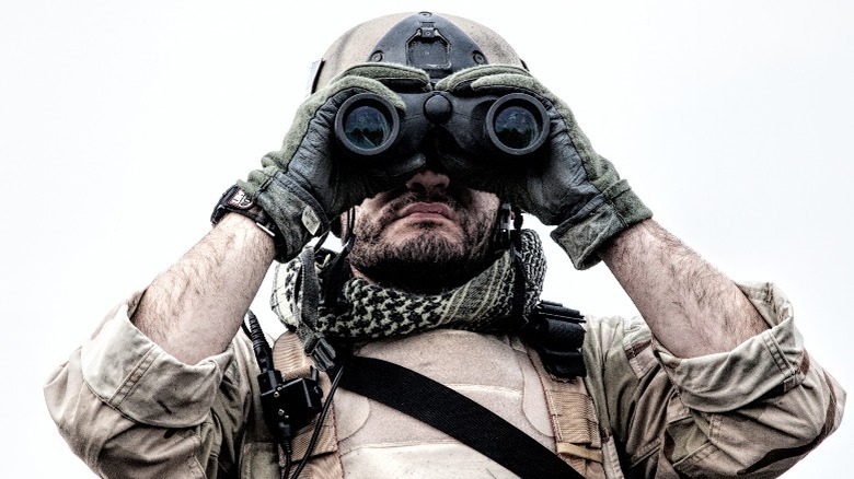 Navy SEAL looking through binoculars