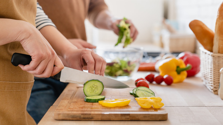 slicing vegetables on cutting board