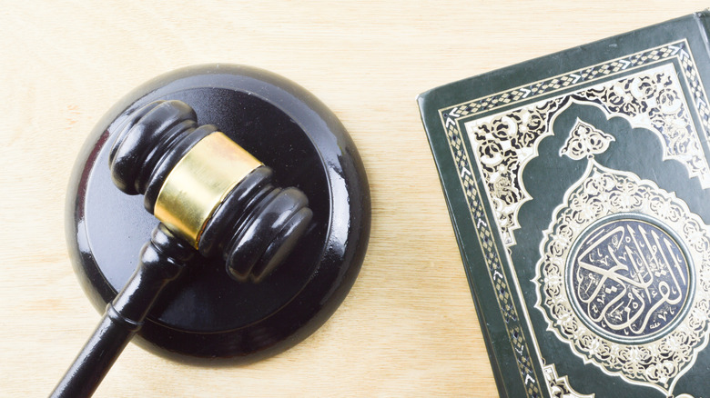 The Quran next to a law gavel