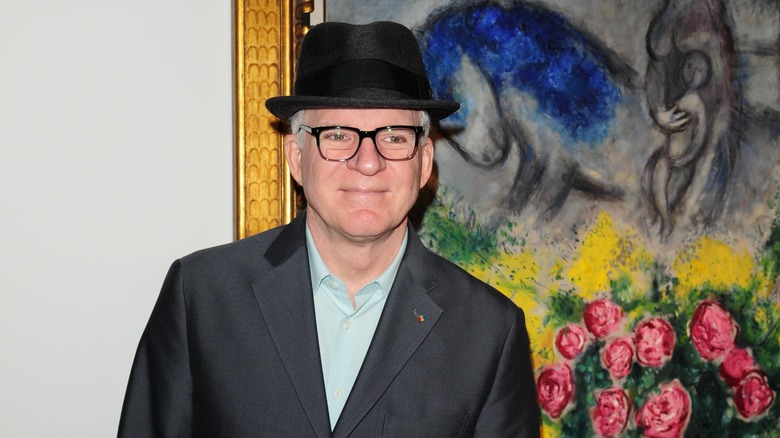 Steve Martin in front of a painting