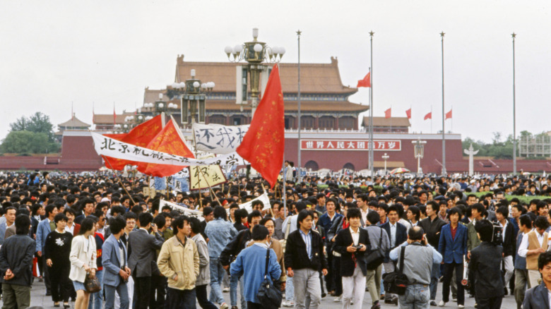 Student protesters holding red flags