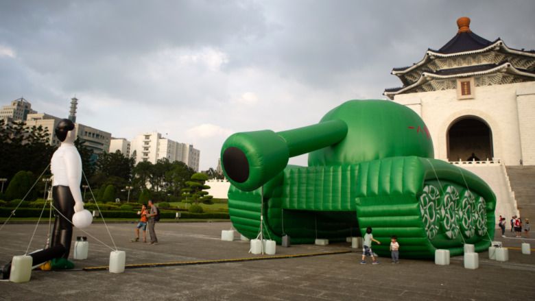 inflatable tank with inflatable figure of a man in front 