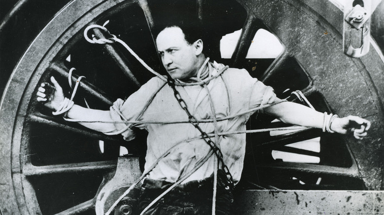 Houdini chained to a wheel