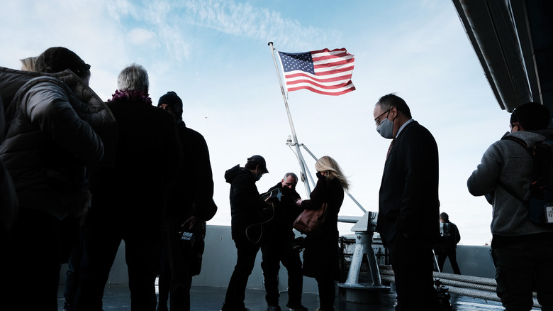 Peal Harbor families raise an American flag