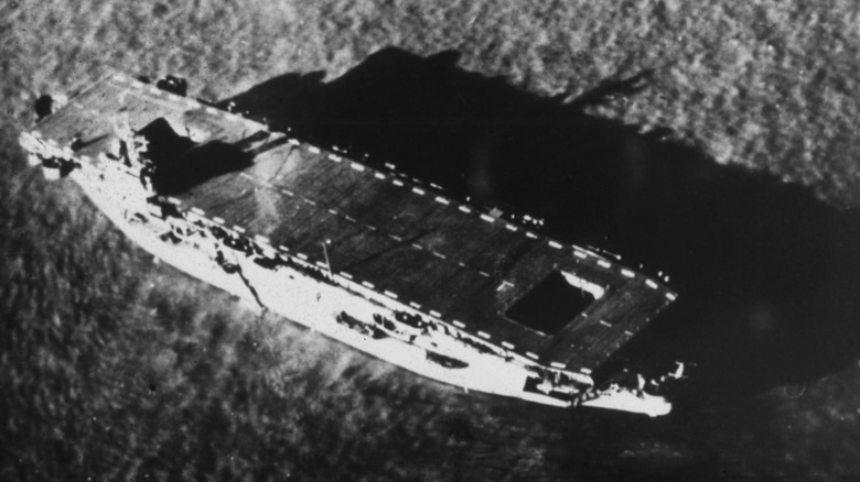 An aircraft carrier sails through sea