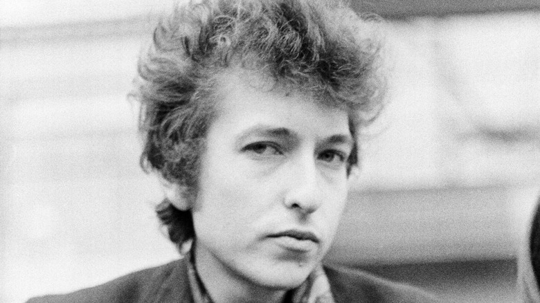 young Bob Dylan with a serious expression 