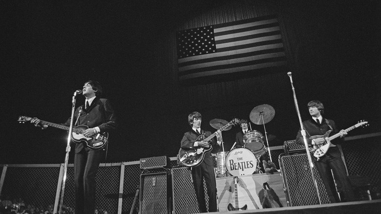The Beatles performing onstage in 1965 