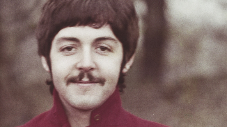 Paul McCartney with red shirt and moustache