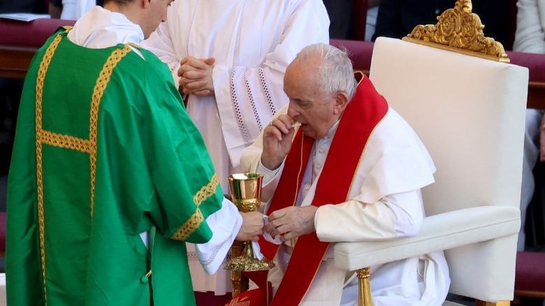 Pope Francis taking Eucharist