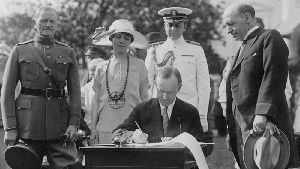 President Calvin Coolidge signs documents in 1924 